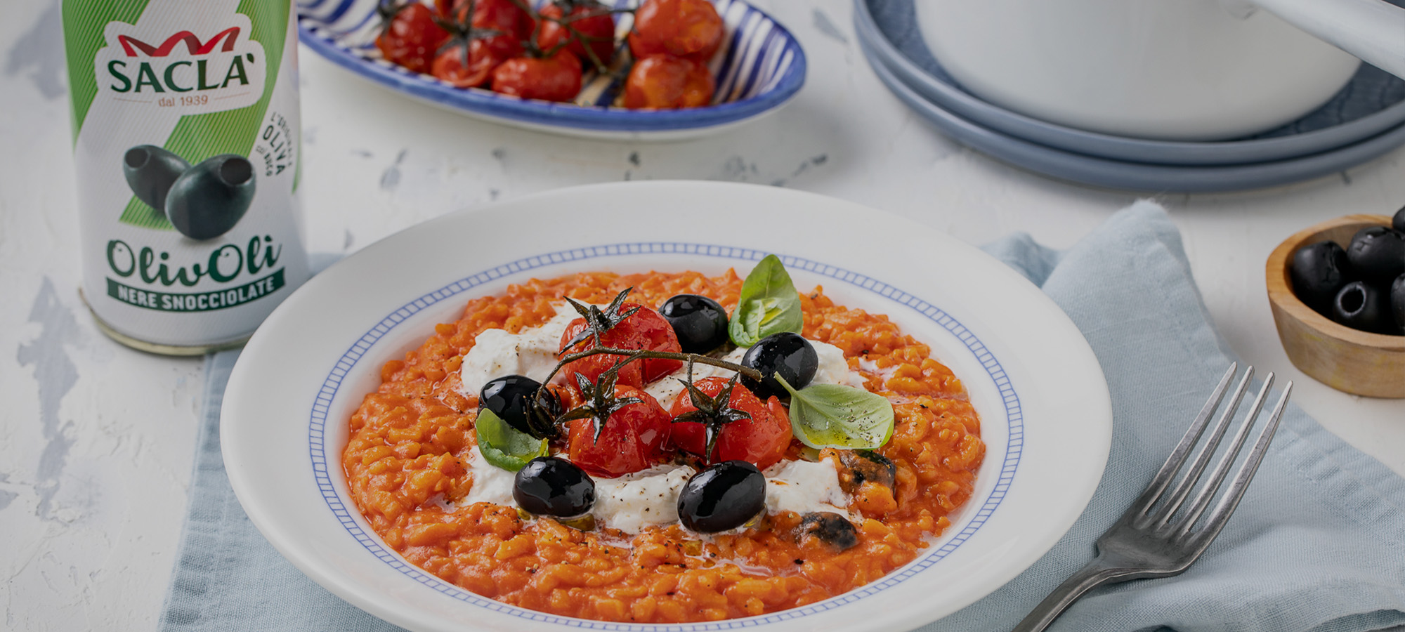 Risotto al pomodoro, burrata, Olive Nere Denocciolate e pomodori arrostiti
