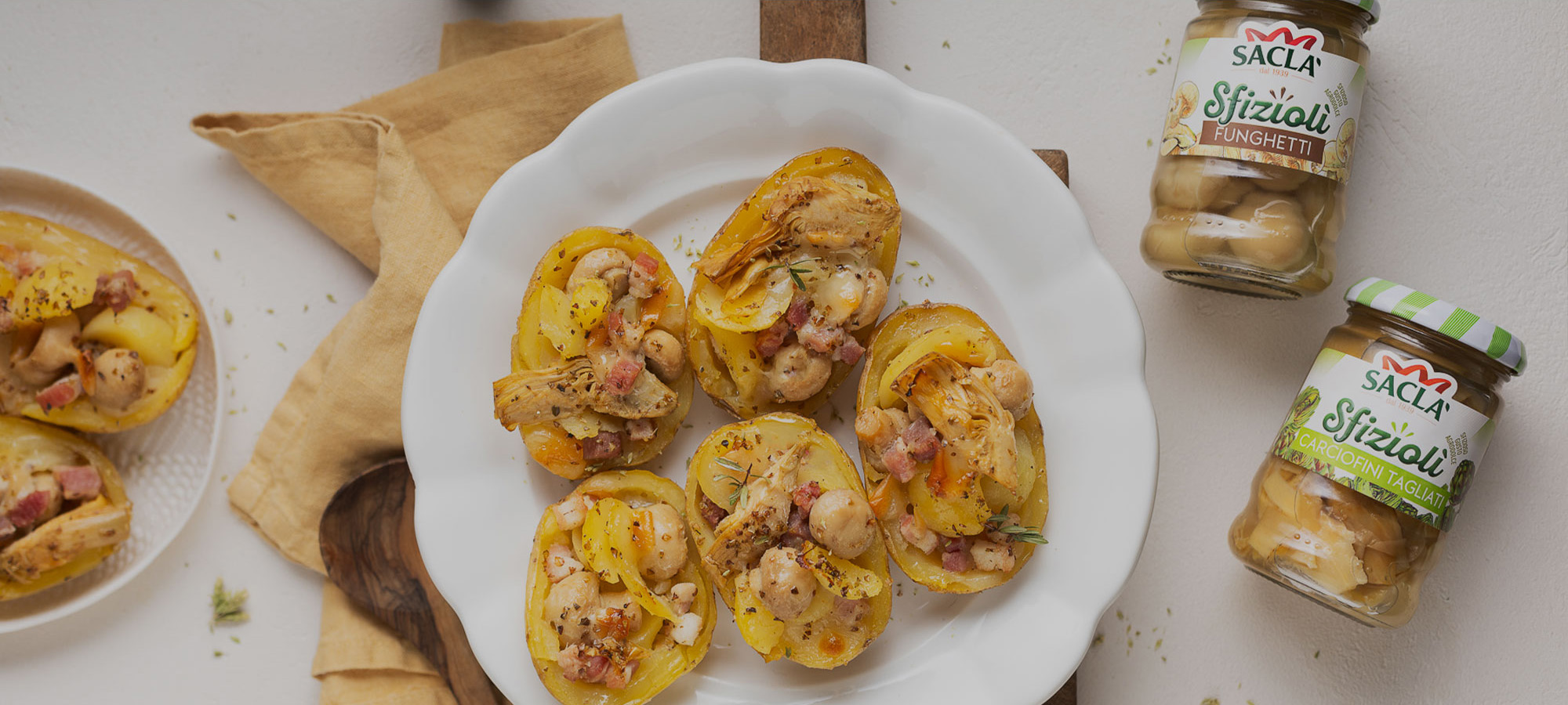 Patate al forno ripiene di scamorza, pancetta e duetto Carciofini e Funghetti Saclà